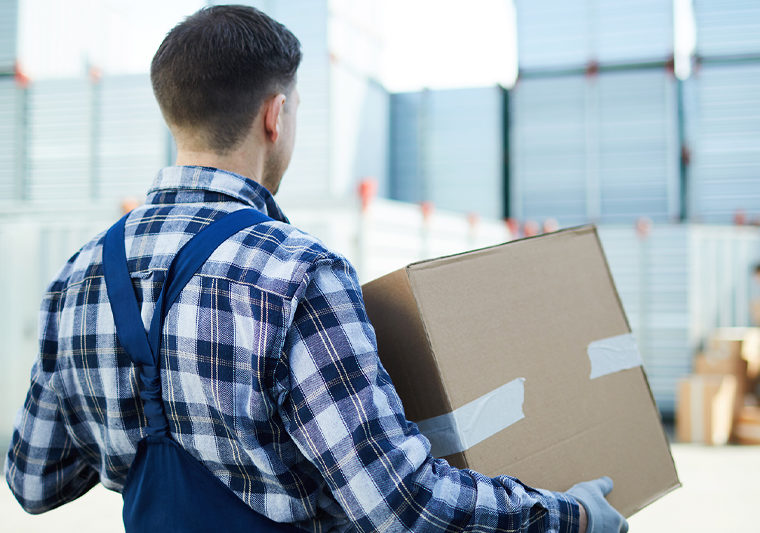 worker carrying box in factory