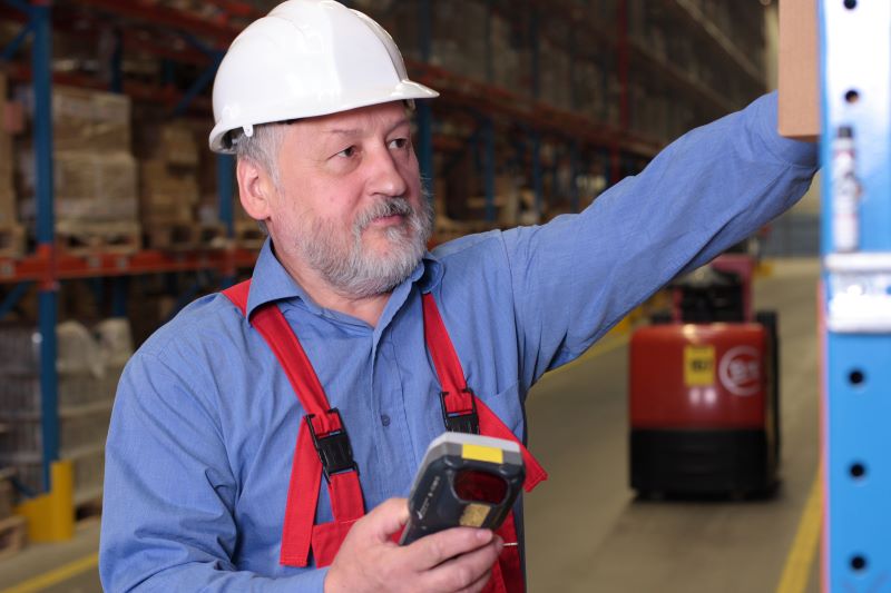 senior worker with bar code reader