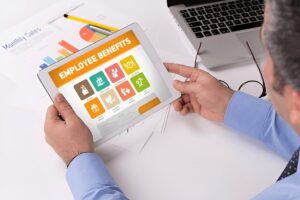 Man working on tablet with Employee Benefits on a screen