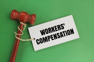 Judge’s gavel with a tag reading “Workers’ Compensation” symbolizes employee protection after workplace injuries.