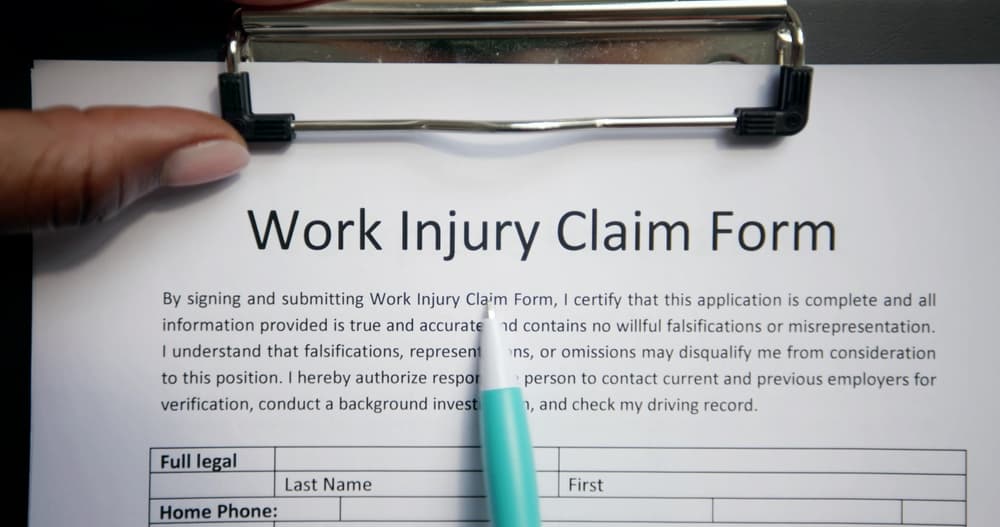 Person reviewing a work injury claim form, symbolizing the hesitation part-time warehouse workers feel when deciding whether to file a workers&rsquo; compensation claim in Indiana.